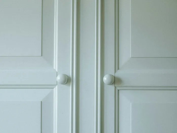 Painted cabinet doors set inside the cabinet frame, flush with the front