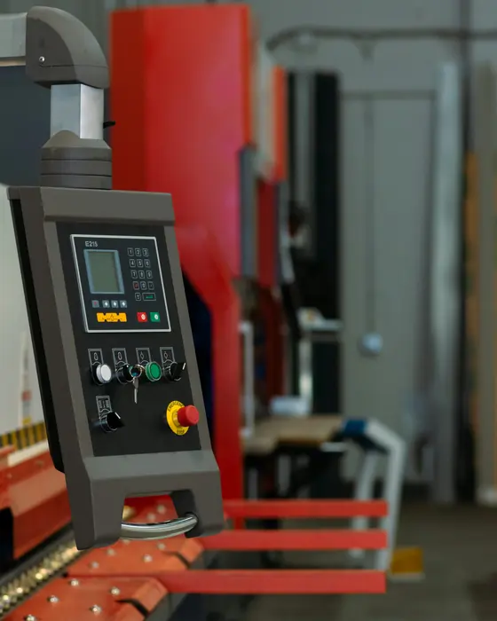 Operator at an orange press brake in a metalworking factory