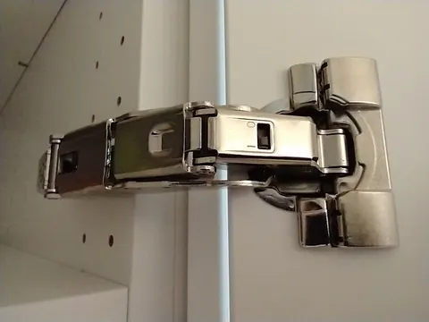 Wide-angle concealed hinge in a white cabinet