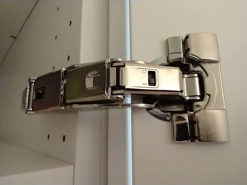 Wide-angle concealed hinge in a white cabinet